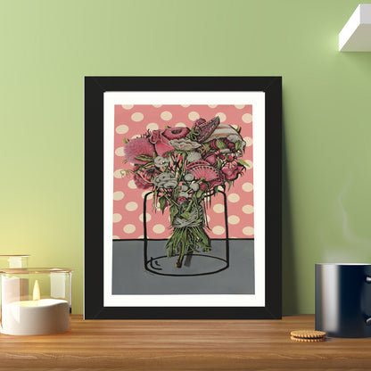 An oil painting with a black frame of a bouquet of flowers tied with a silk ribbon placed on pink gift paper with dots with a jar illustrated on the paper. The image is suitable for any space. Also for a coffee corner in the workplace. Everywhere the painting will add beauty